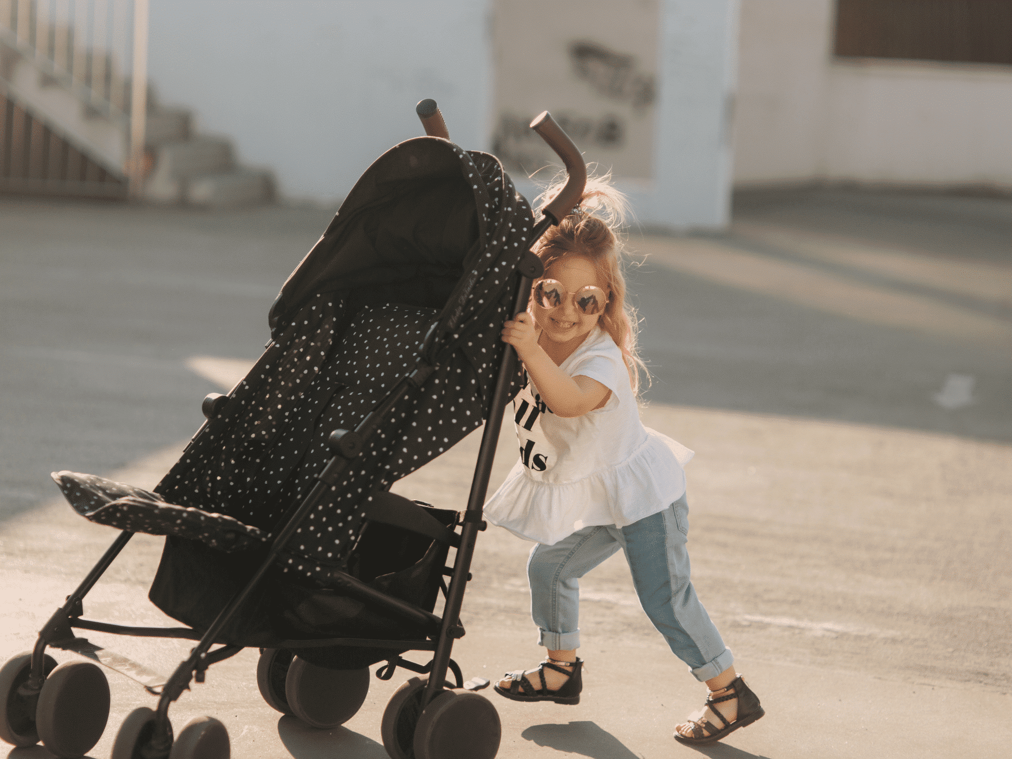Young child pushing a stroller in New Orleans 