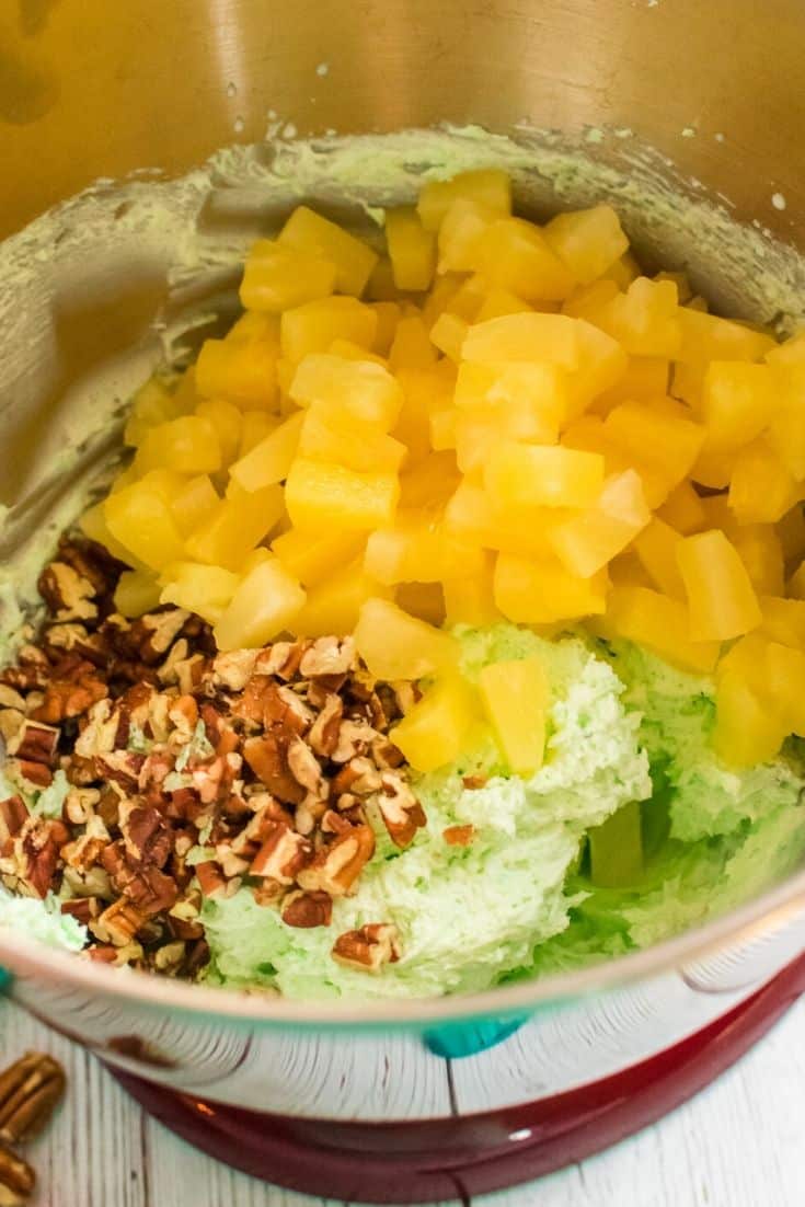 adding in the pineapple and pecans for watergate salad